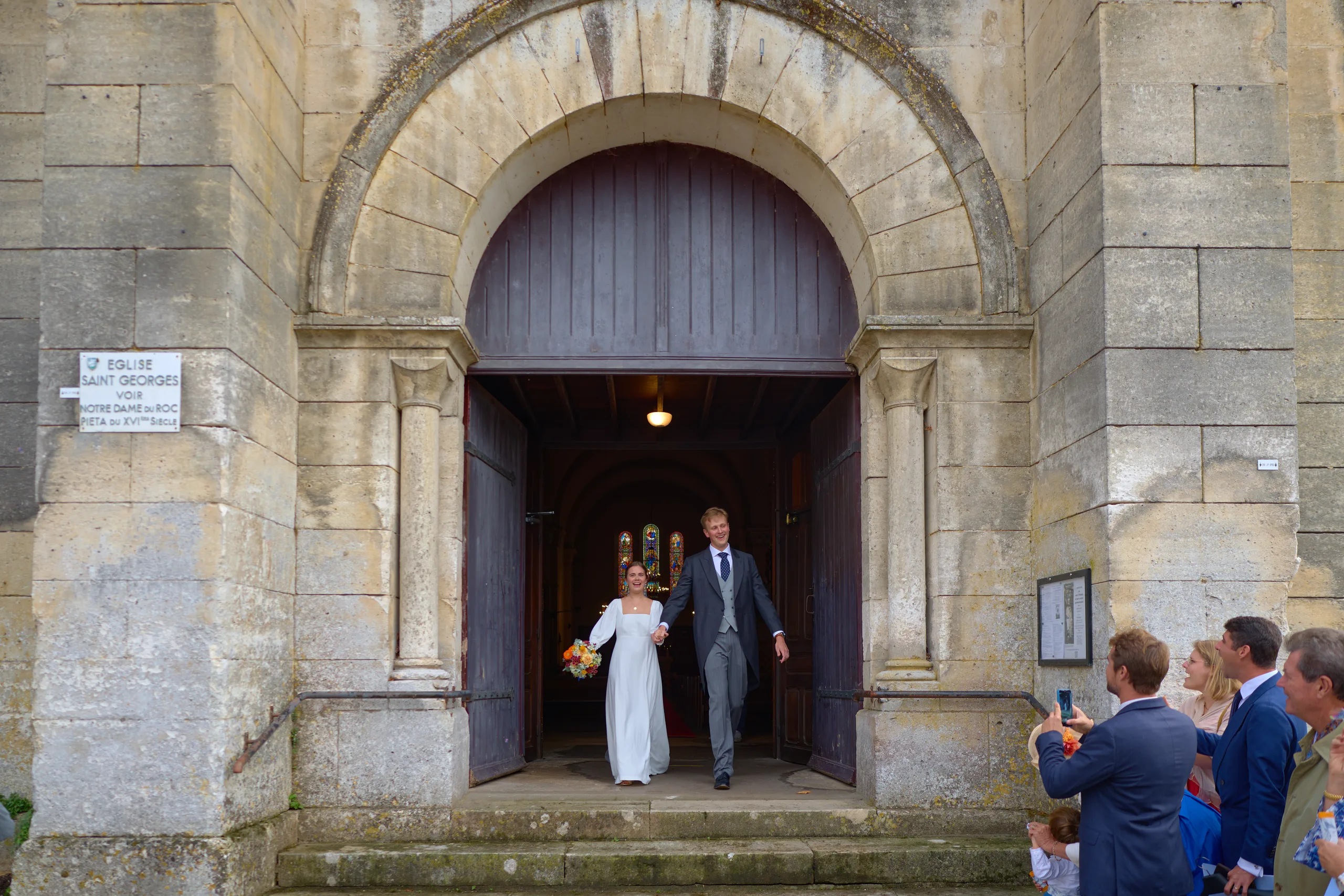 Jade and Luc leaving their wedding ceremony