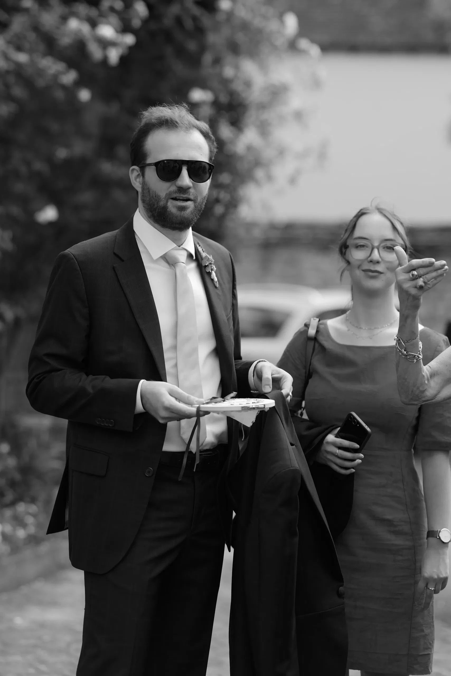 The newlyweds walking past the vintage aircraft