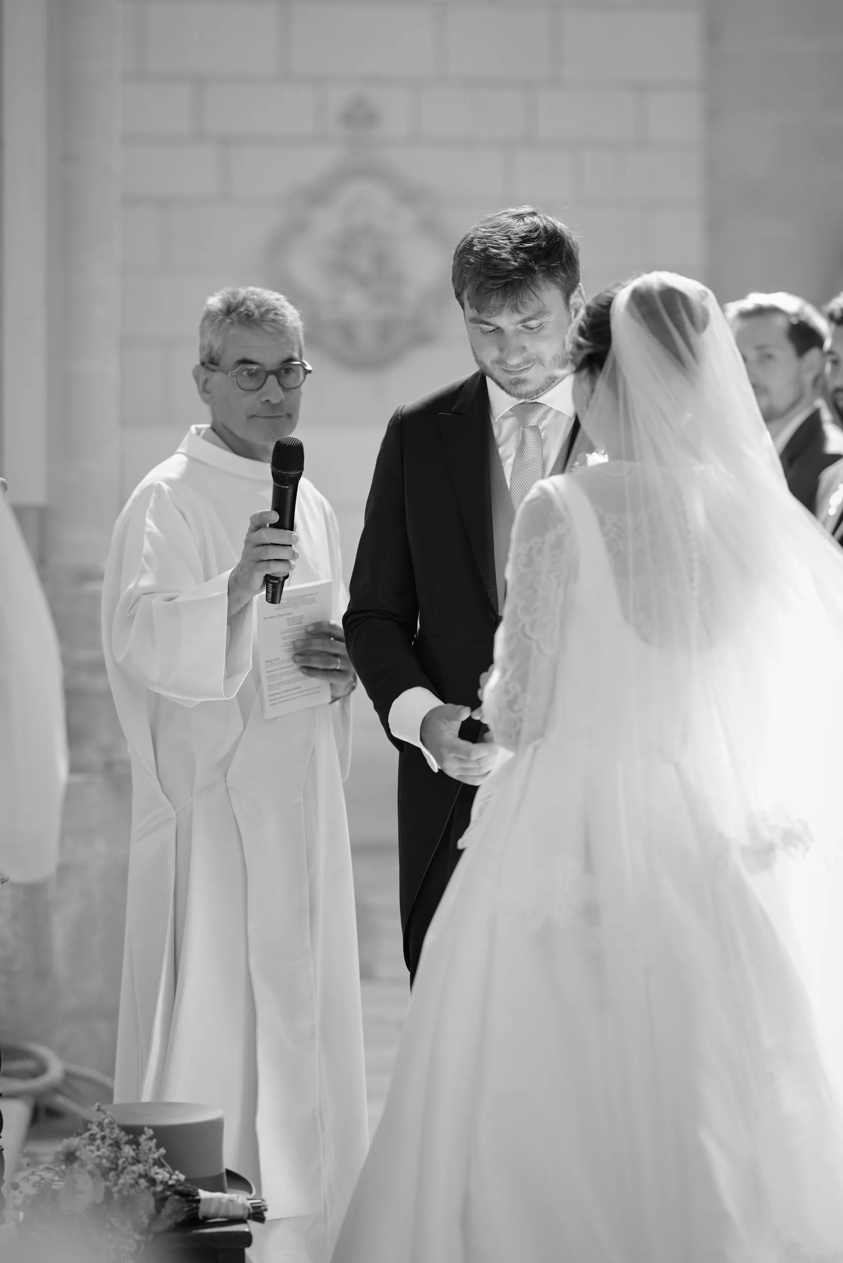 Deux personnes en tenue de cérémonie dans l’église, en noir et blanc