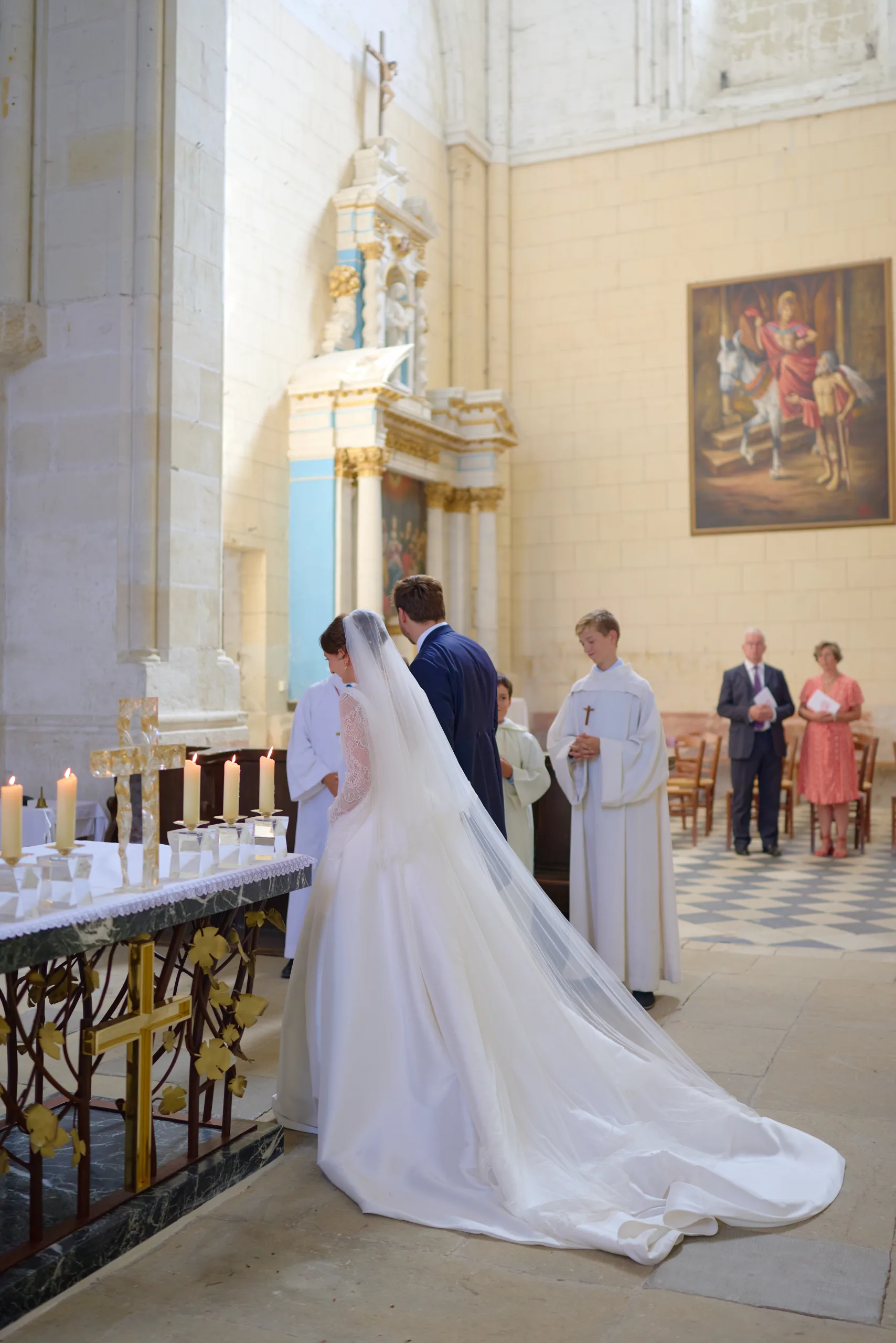 Femme en robe blanche près de l’autel
