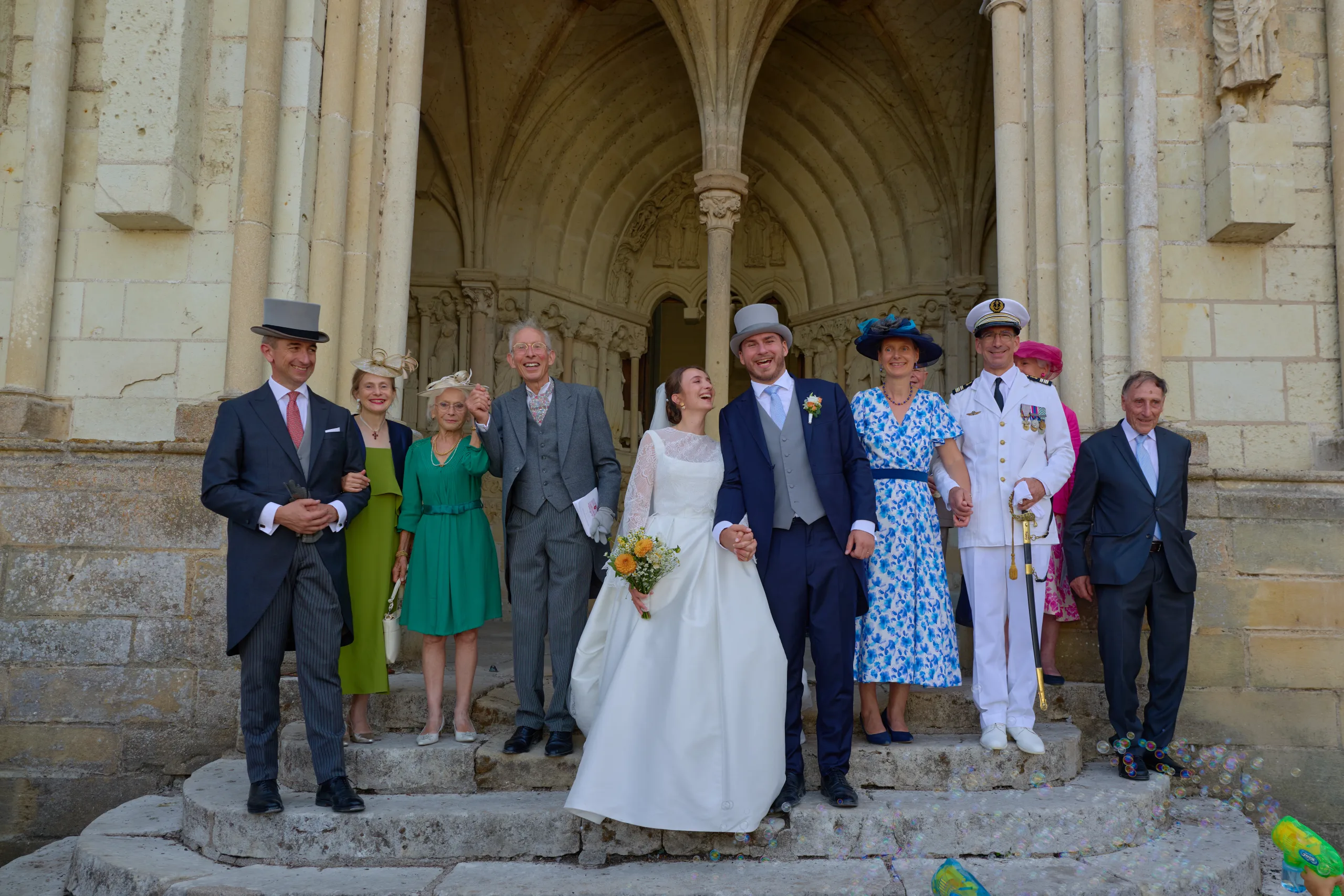Les mariés entourés de leurs invités sur les marches de l’église