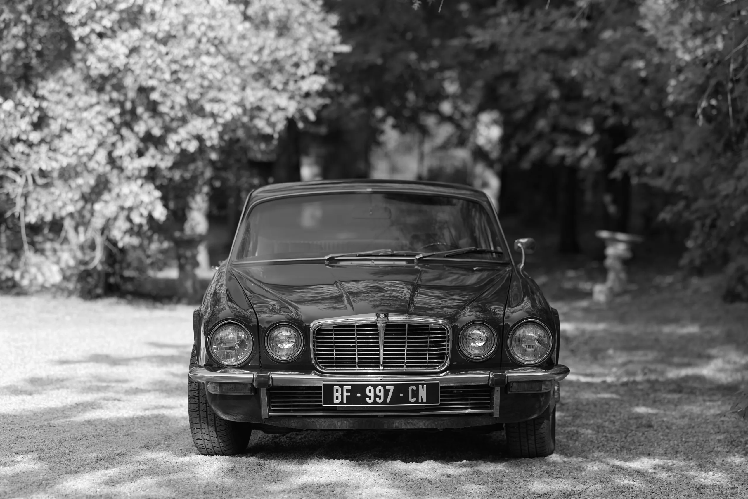 Vue de face d’une voiture ancienne, en noir et blanc