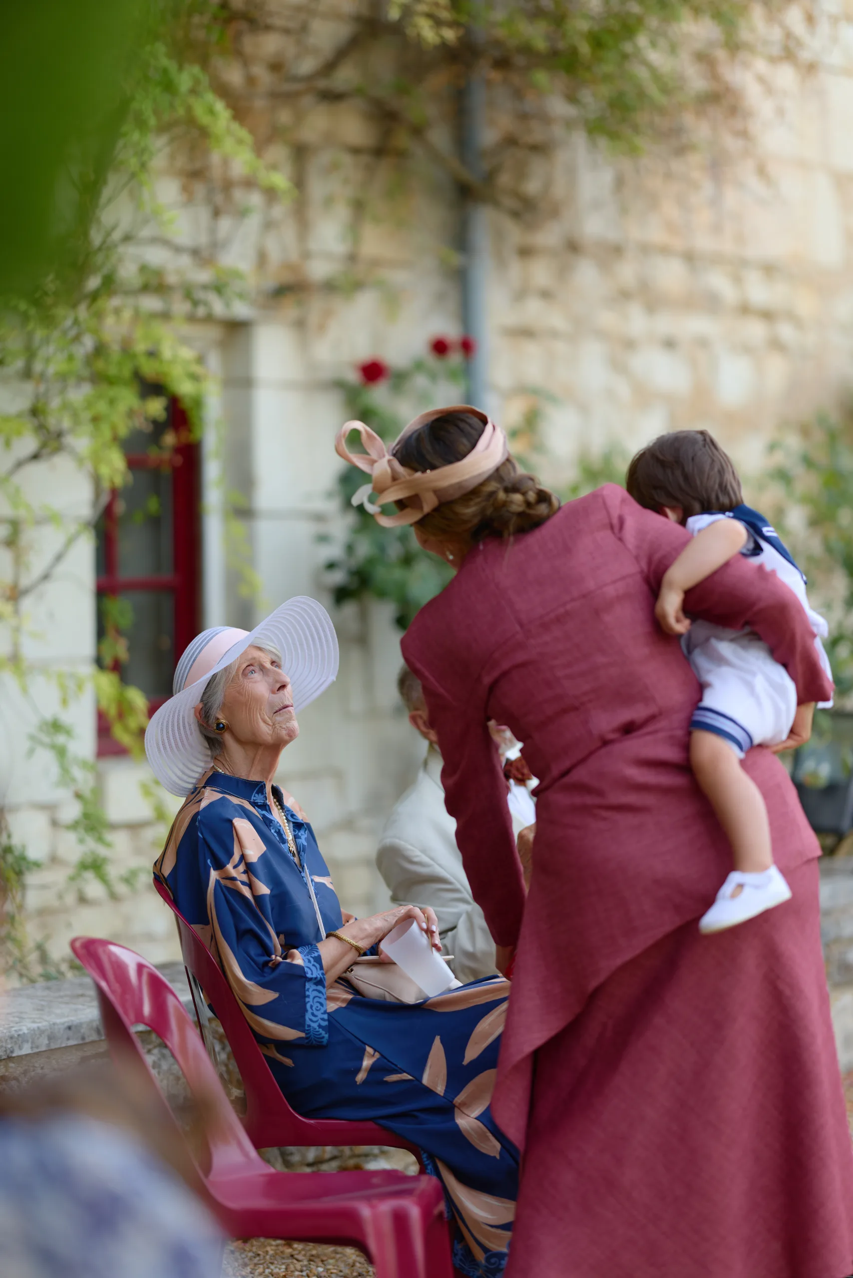 Une invitée avec un enfant salue une femme assise
