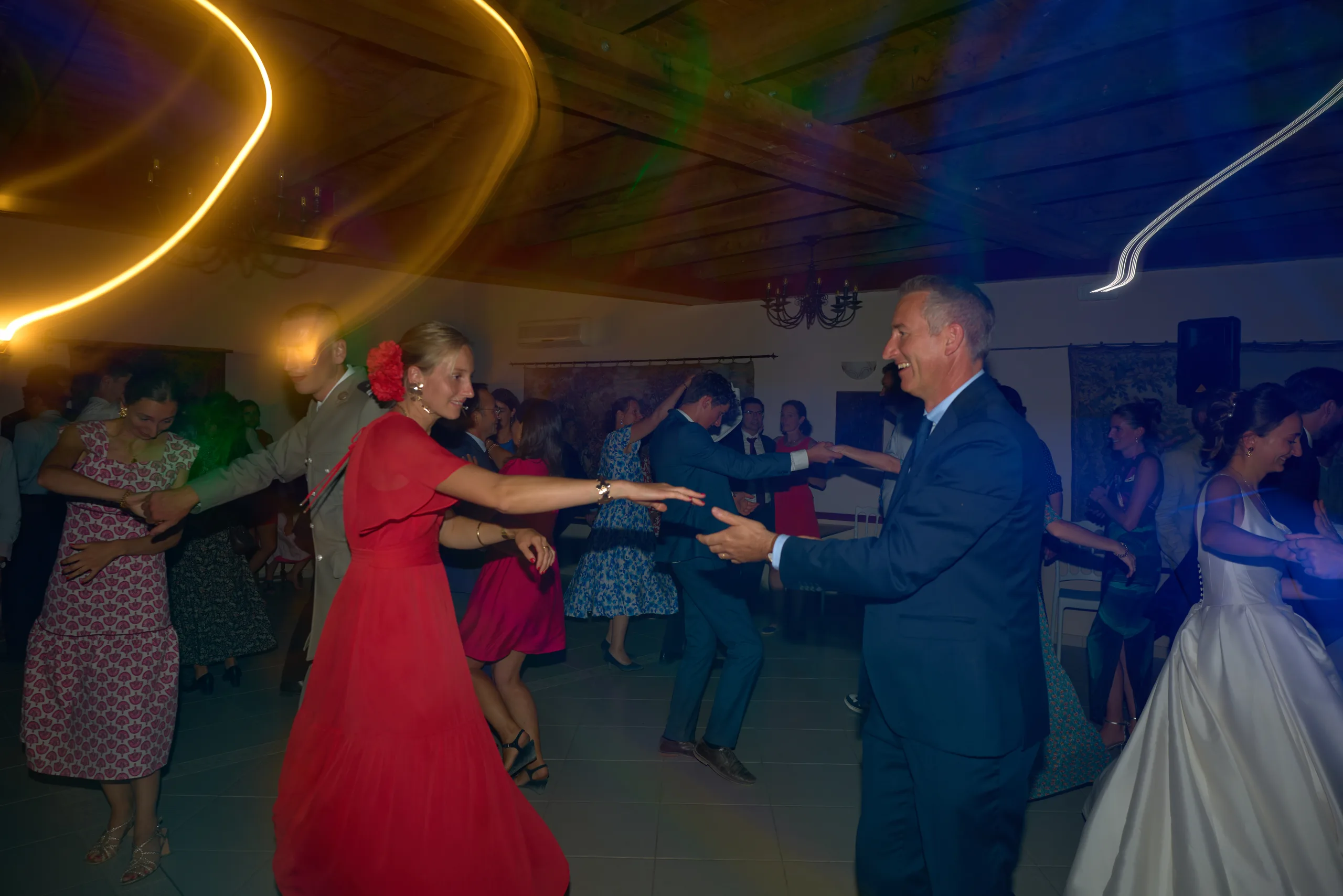 Un couple danse sous des traces de lumière colorées